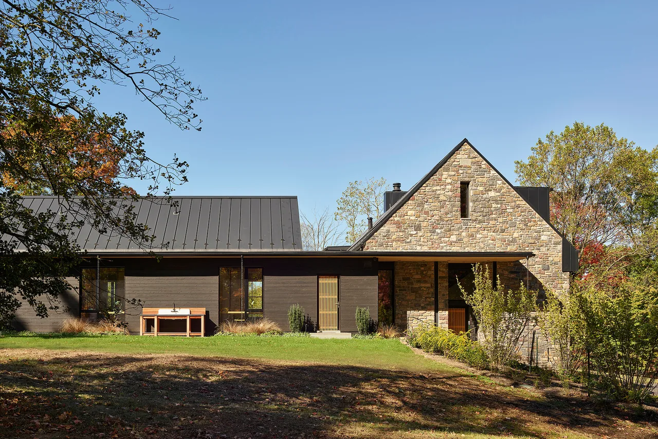 Bucks Retreat exterior features stone and wood siding with metal shed and gable roofs.