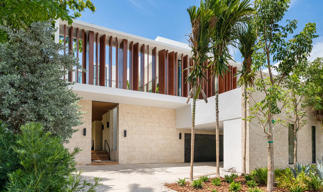 Modern two-story house featuring vertical wooden slats and stone exterior walls.