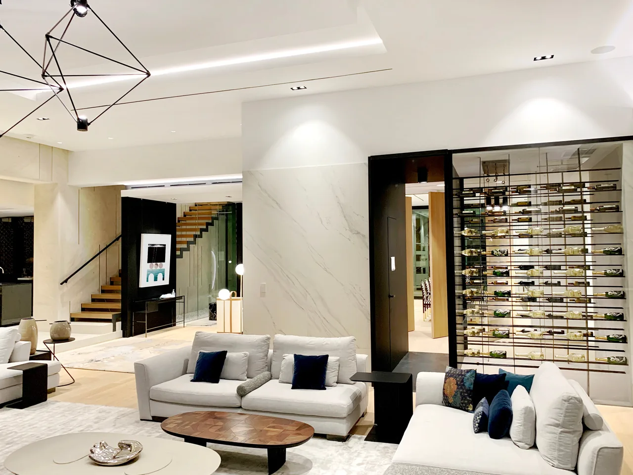 Interior living space featuring minimalist modern design with a fireplace, seating area, and staircase.