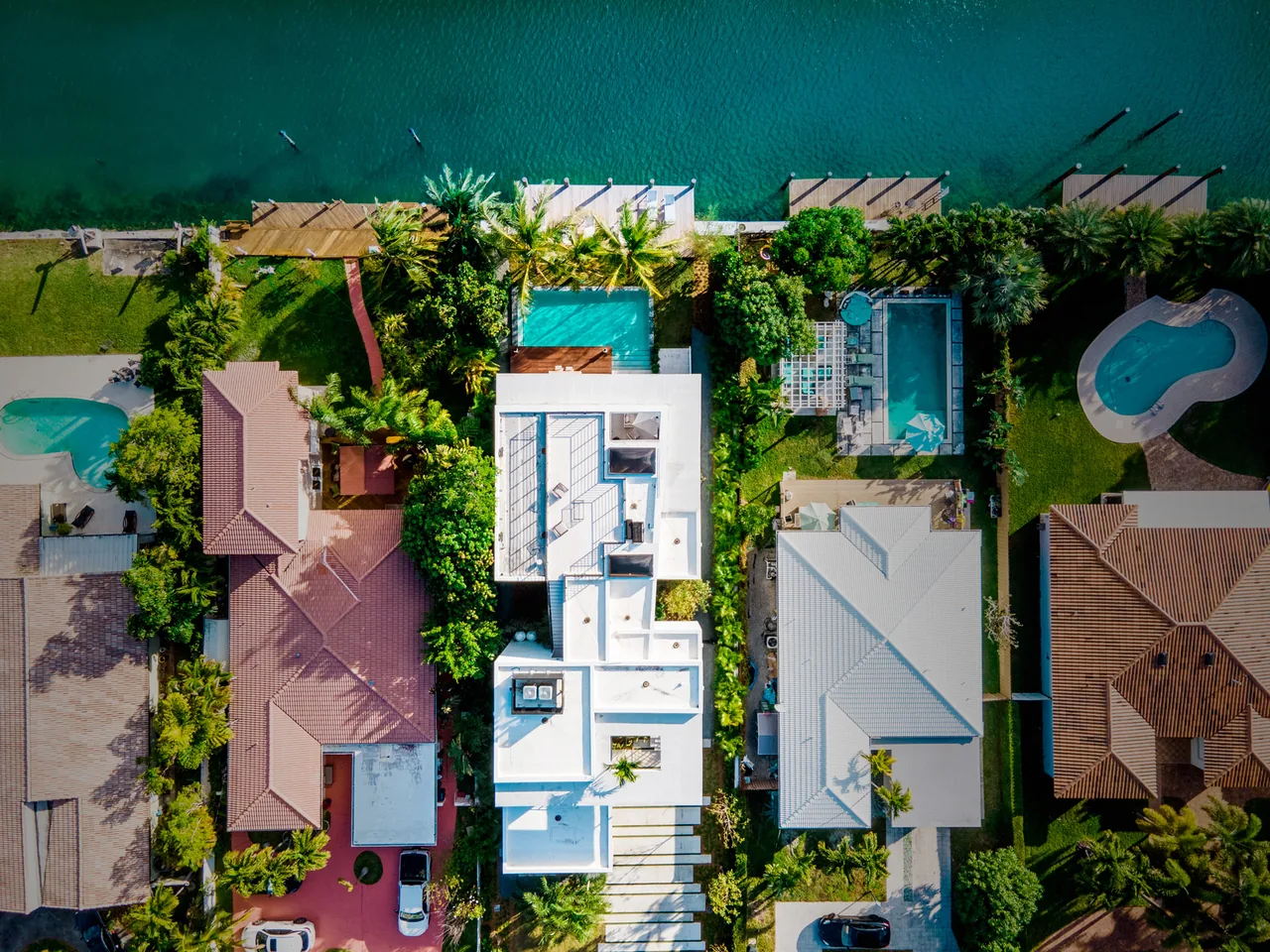 Aerial view of Normandy Island S.Shore I featuring a flat roof, a swimming pool, and dock access to the canal.