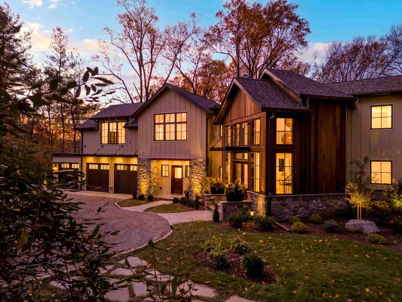 Parkside Sanctuary features a wooded lot home with three-car garage and a driveway loop that includes a landscaped island.