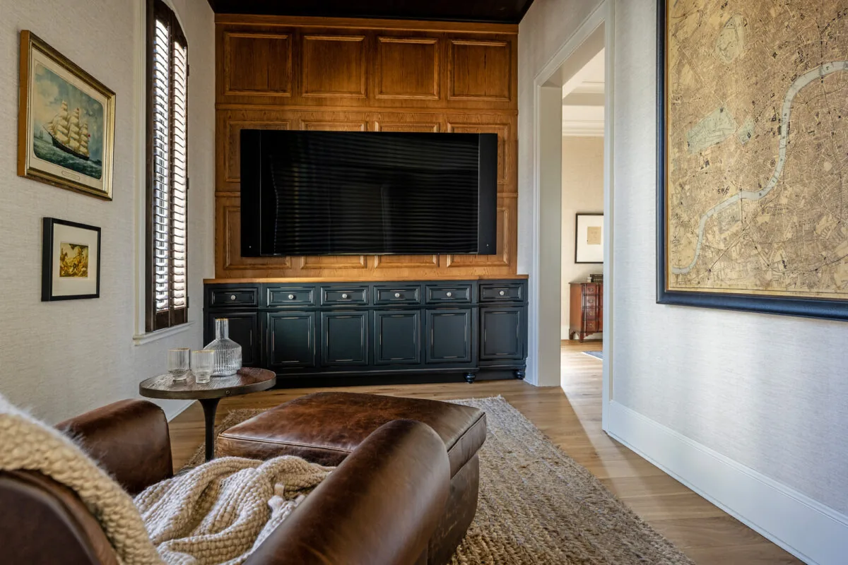 Living room features a large wood-paneled TV wall, leather seating, and soft neutral tones.