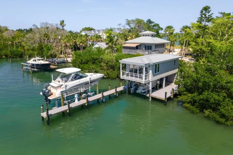 Tide House features an elevated structure with a metal roof, a boat dock, and clear views of the water.