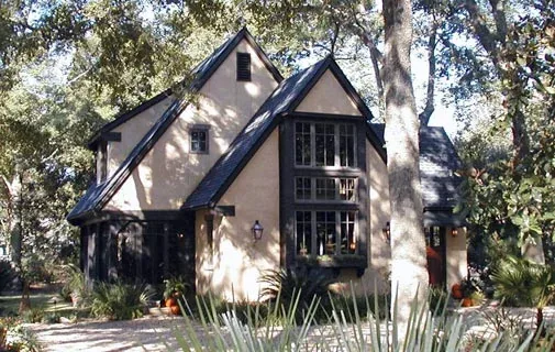 The Verneuille Residence features steep gable roofs and a shaded facade with stucco exterior.