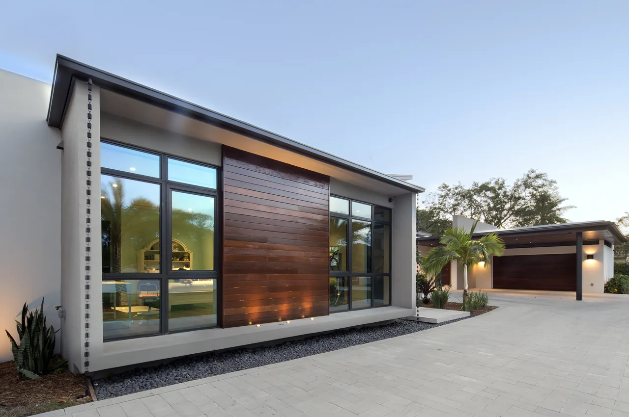 ALF Residence features modern architecture with large window panels and wood siding.