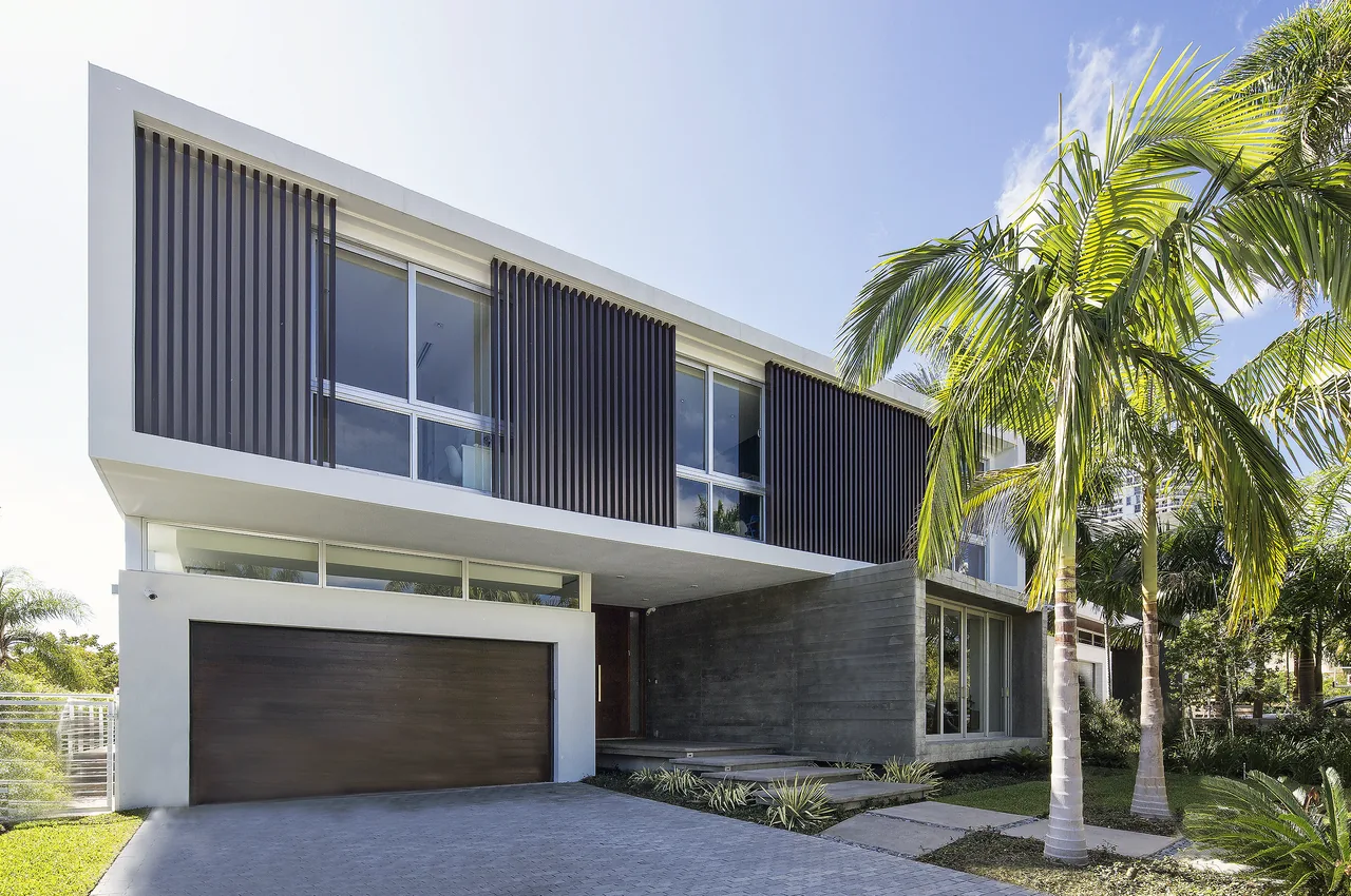 Wex Residence features a modern façade with wood slat shading, concrete wall elements, and large windows.