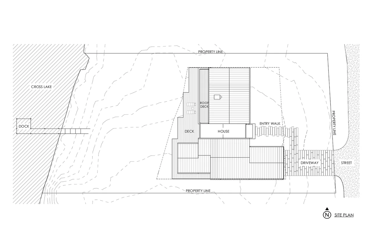 Site plan for the Whitefish Lakehouse showing the house footprint, roof deck, dock, and driveway leading to the street.