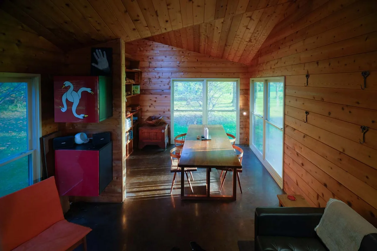 The Playhouse features wood-paneled walls, large windows, and a simple dining area with natural light.
