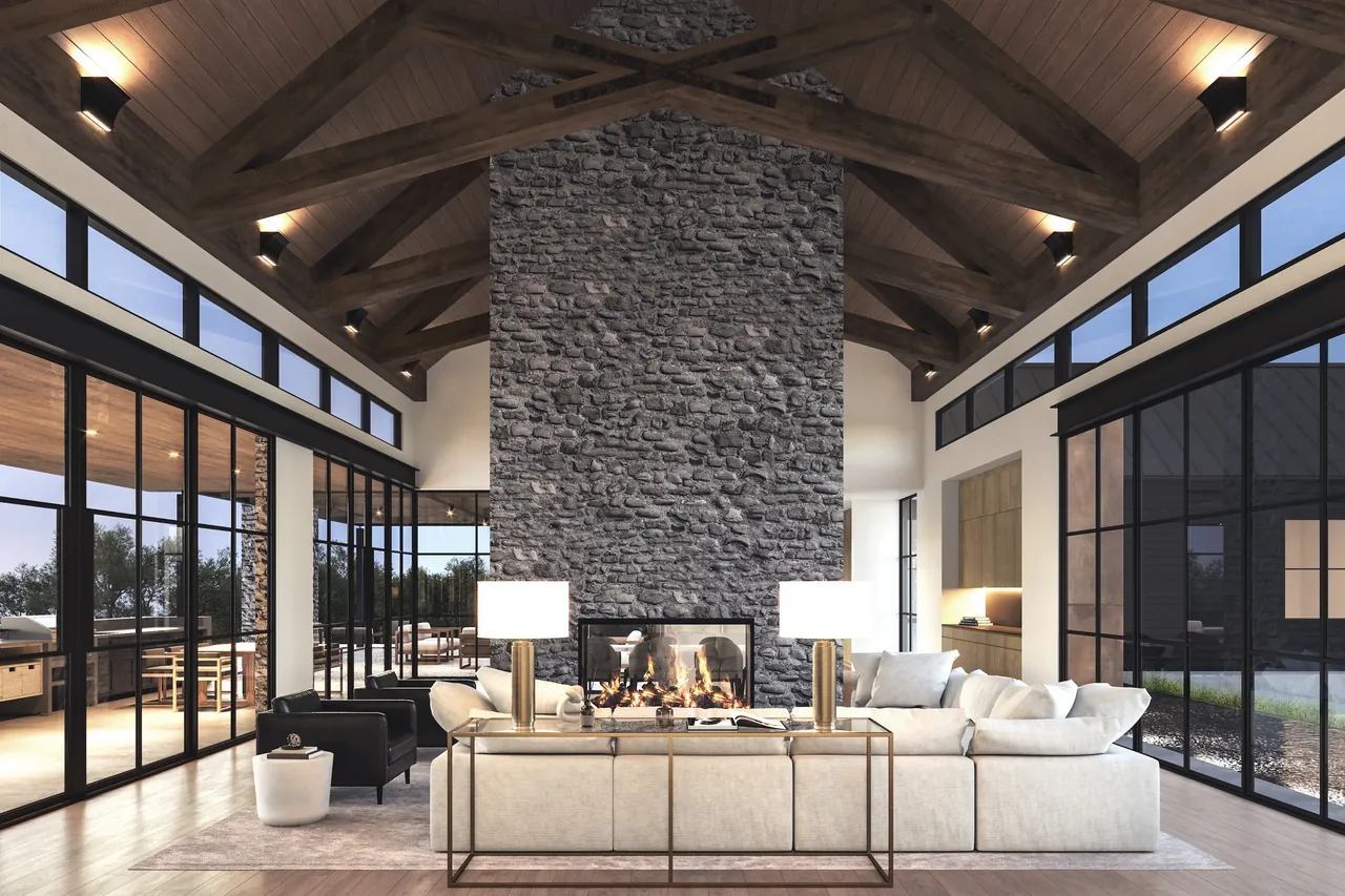 Rabbit Ridge living room features a double-sided stone fireplace under a vaulted wood ceiling with extensive black-framed glazing.