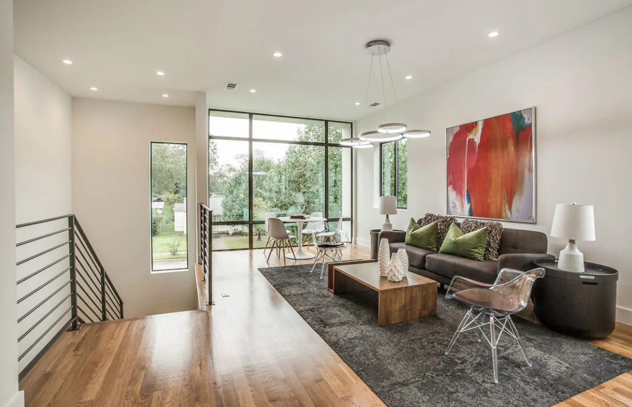 Open living room and dining area with large windows providing garden views at Ribbon House