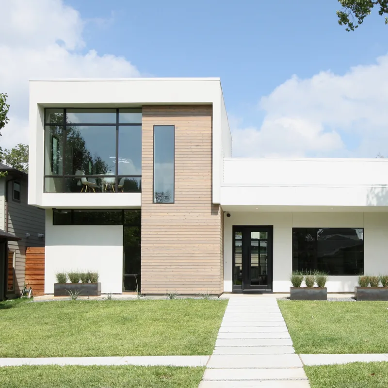 Ribbon House in Dallas features a modern design with large black-framed windows and wood siding.