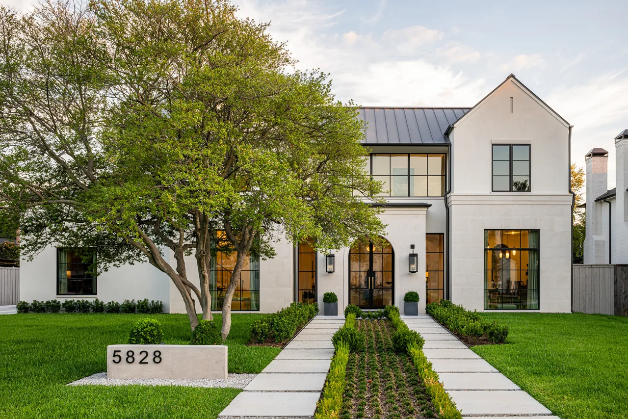 Modern two-story house with a landscaped walkway and arched double glass door entry by Studio Park Architecture.