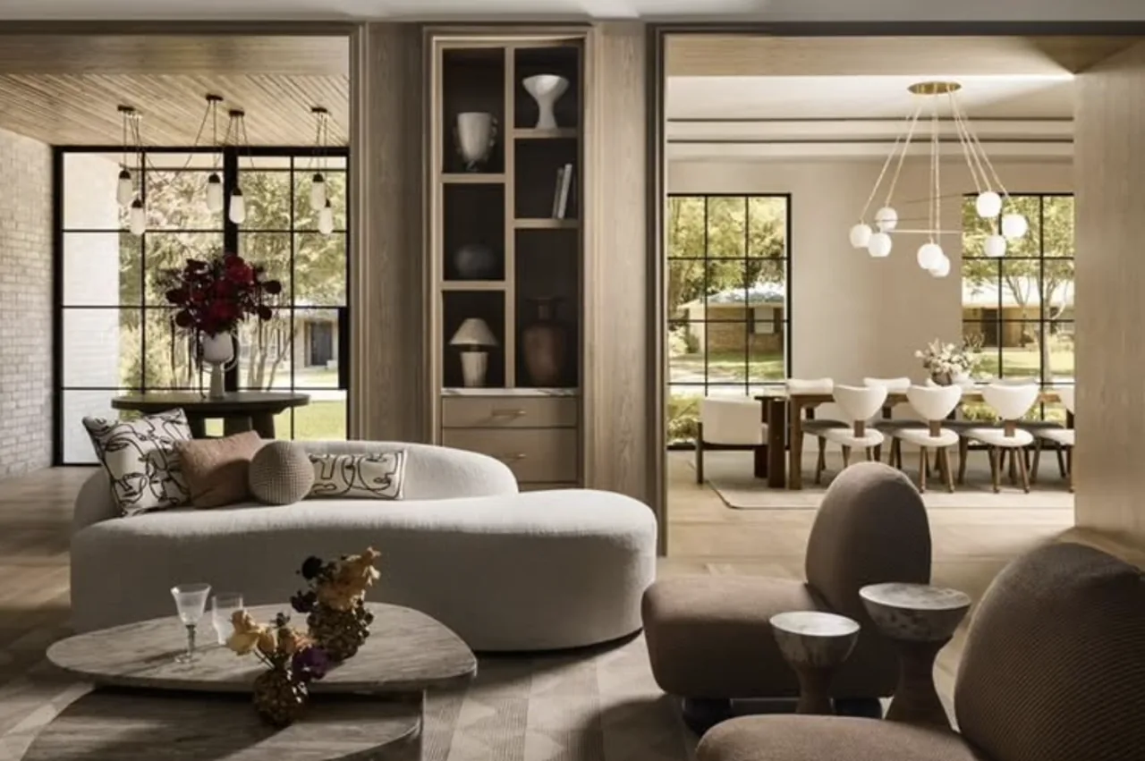 Living and dining areas with large grid windows, curved sofa, and modern pendant lighting in the CABANA LANE project.