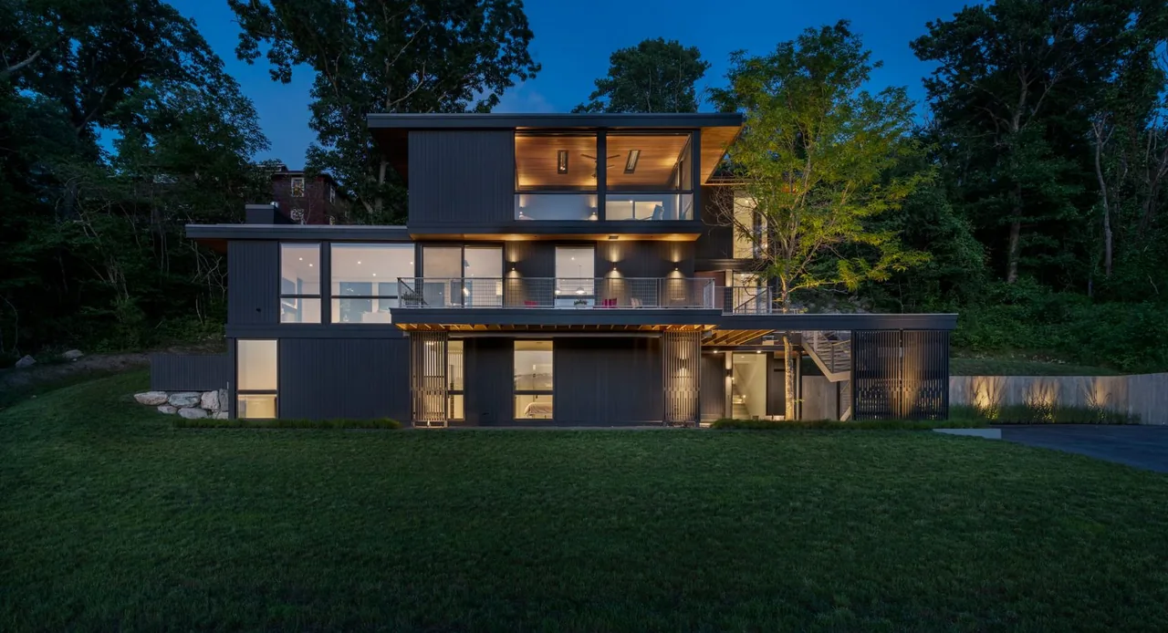 The Tidal Marsh Overlook features a multi-story design with vertical wood paneling and expansive glazing walls by Flavin Architects.