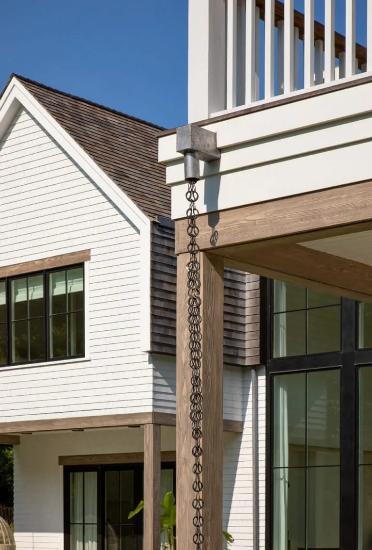 Amagansett House features white shingle siding with wood trim and black-framed windows.