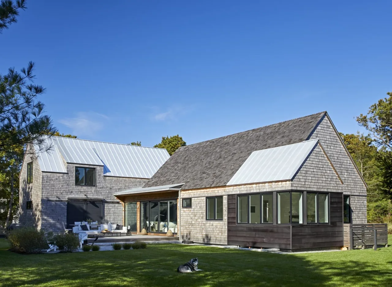 Katama Cove project showing two connected buildings with wood shingle siding and gray metal pitched roofs.