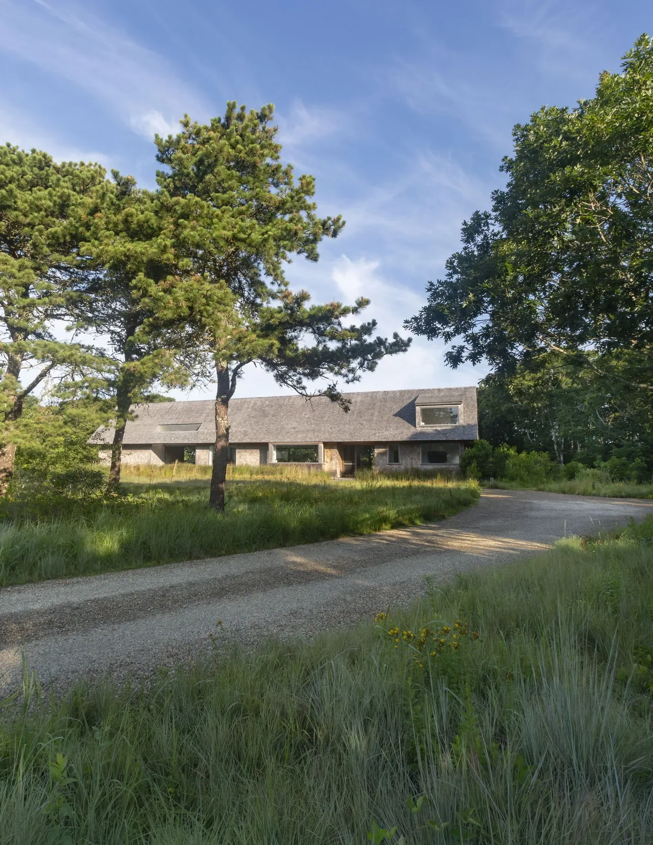 Exterior front view of Wink House by Noury-Ello Architects showing the pitched roof and natural setting near Boston.