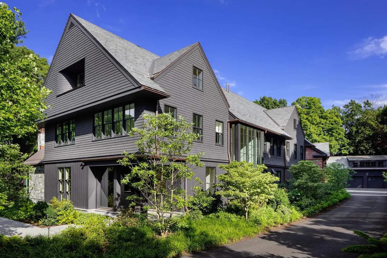 The Carriage House features multiple dormer windows and landscaped gardens along a paved driveway.