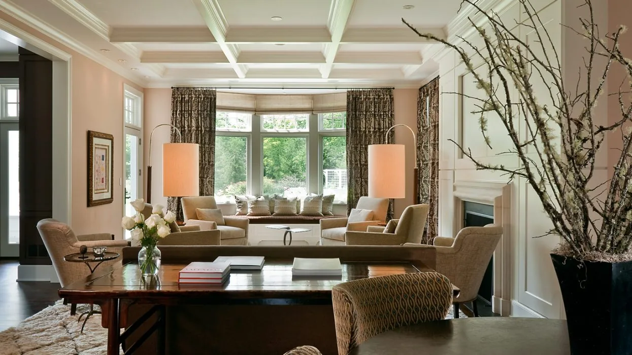 Living room features a coffered ceiling, bay window seat, and a fireplace with classic wall paneling.