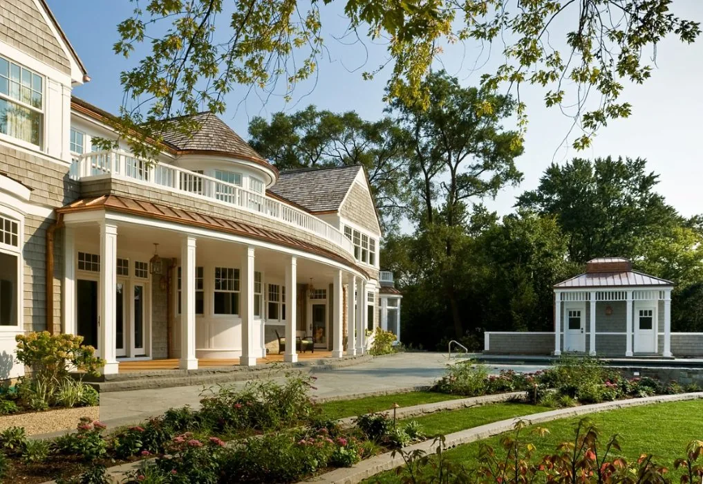 This featured project 'getaway' by Fraerman Associates Architecture shows a curved porch with copper roofing and a small poolside structure.