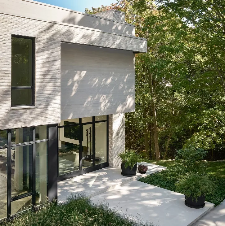 Exterior view of Ravine Reimagined project featuring large black window frames and horizontal siding by Jaffe Architecture.