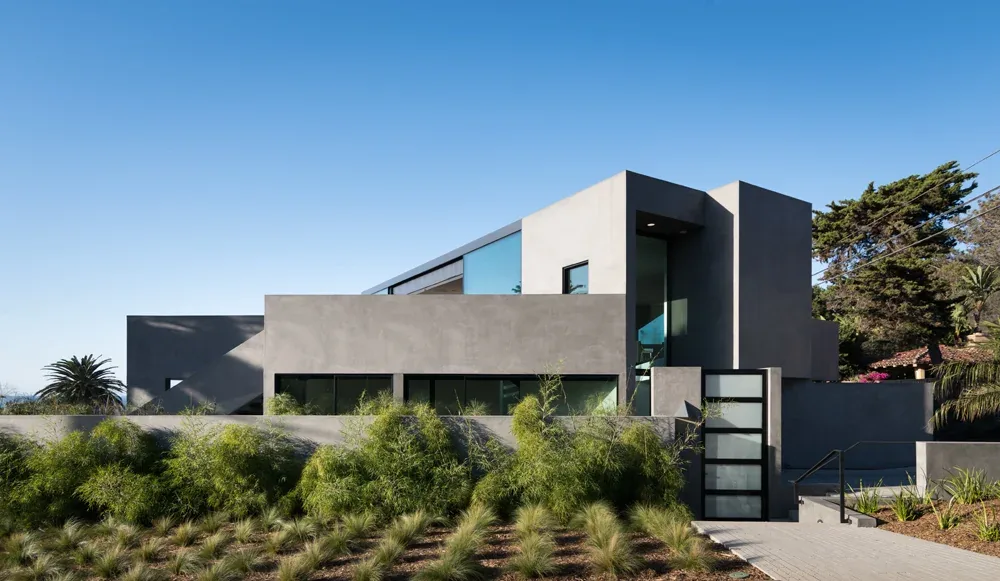 Neptune House features a modern design with prominent corner windows and stucco exterior walls.
