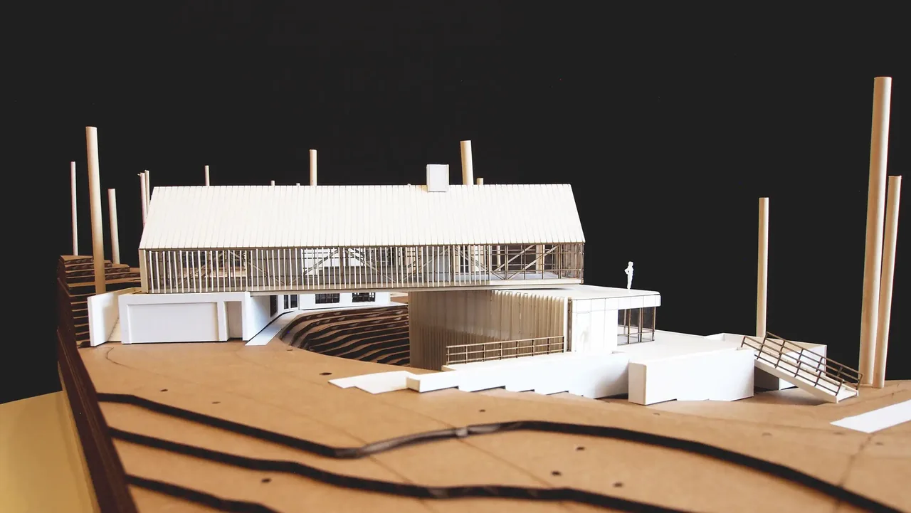 Model of Lakeside House with vertical wood slats and a pitched roof by Collective Office.