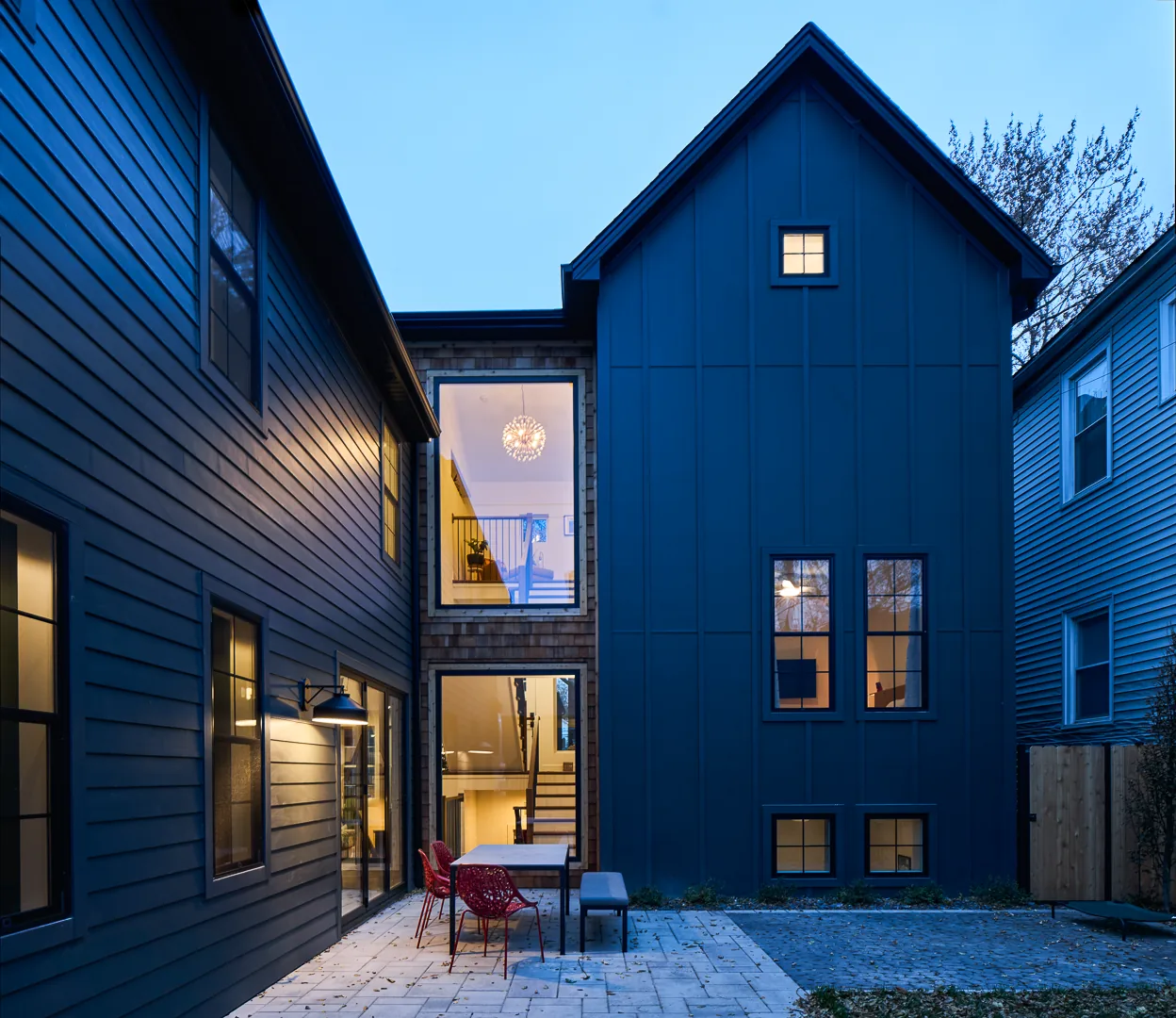 The Mozart House features a two-story exterior with large windows and a paved courtyard patio.