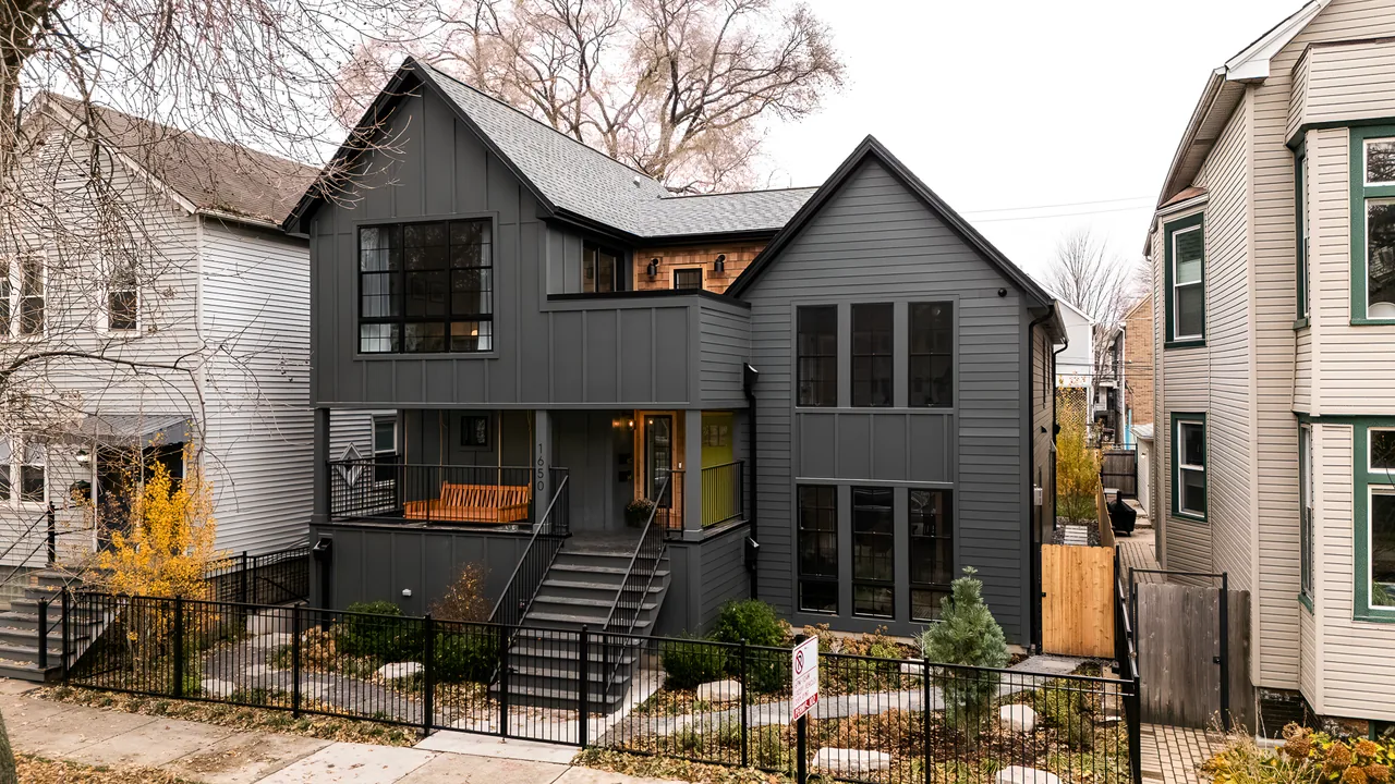 Exterior front view of The Mozart House with dark gray siding and black window frames.