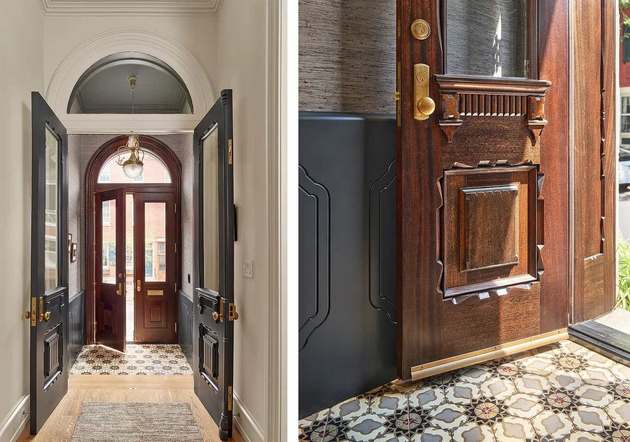 Entryway with detailed dark double doors opening to a wooden arched front door featuring glass panels and an arched window above.