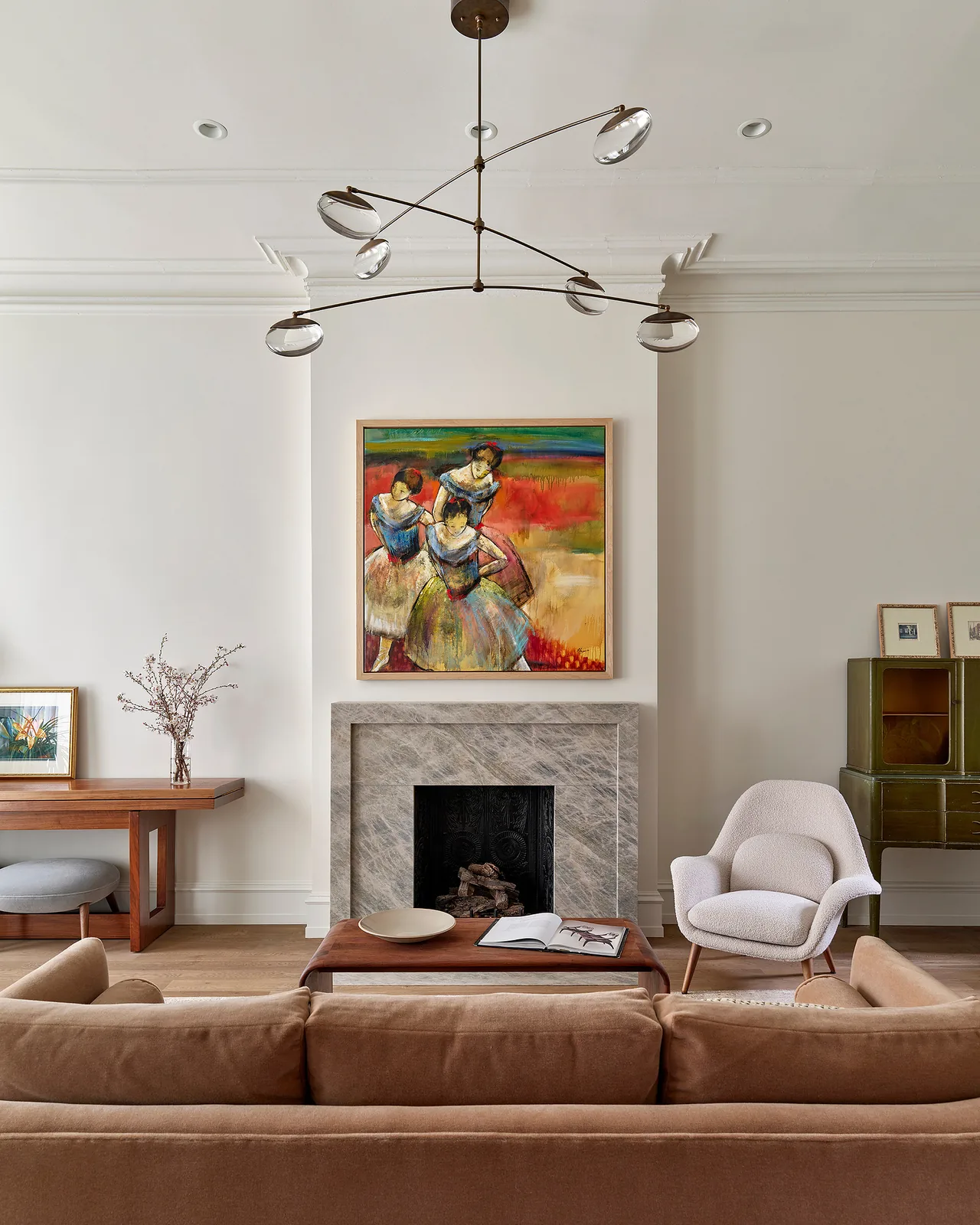 Fitler Square Renovation features a marble fireplace and contemporary lighting in the living area.