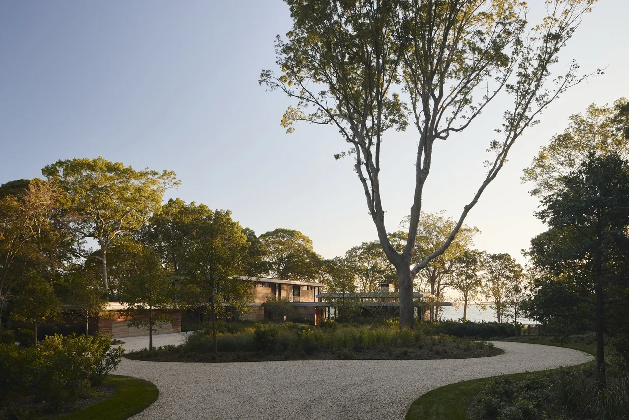 Forest Edge features a contemporary facade with horizontal wood siding and integrated landscaping.