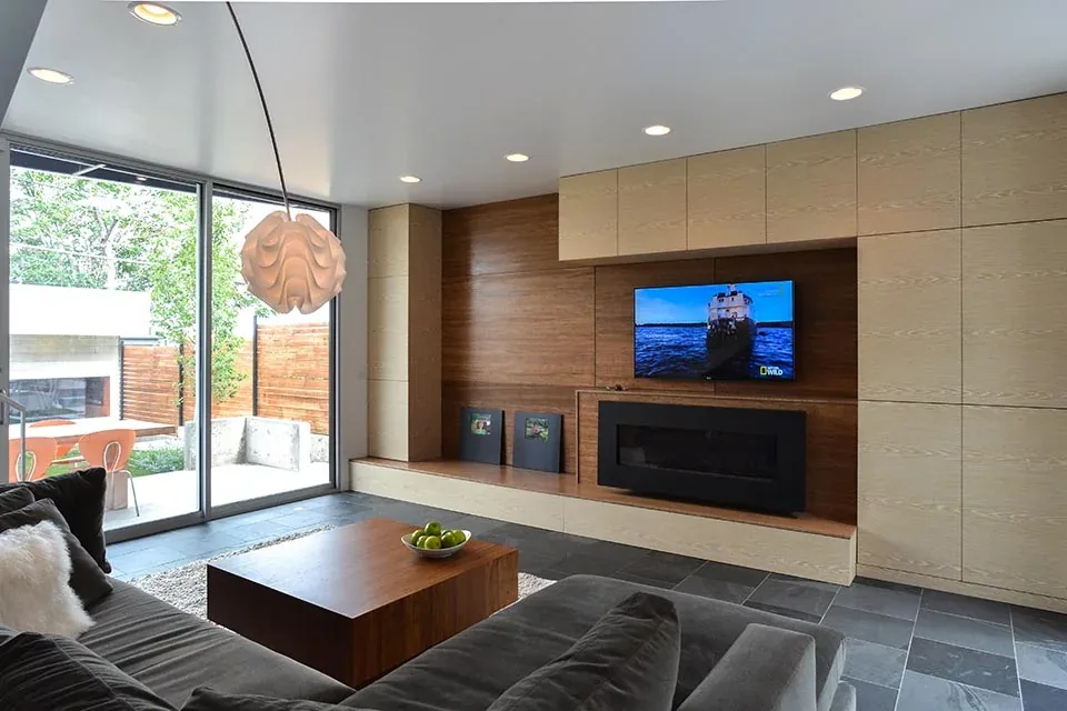 Living room features wood cabinetry with a built-in linear fireplace and large sliding glass doors to outdoor space.