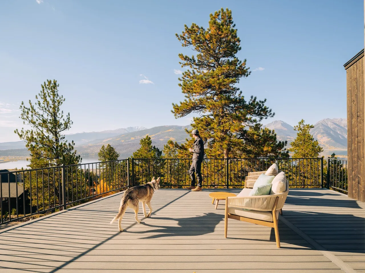 Twin Lakes Bothy features an elevated outdoor deck with metal railing and mountain views.