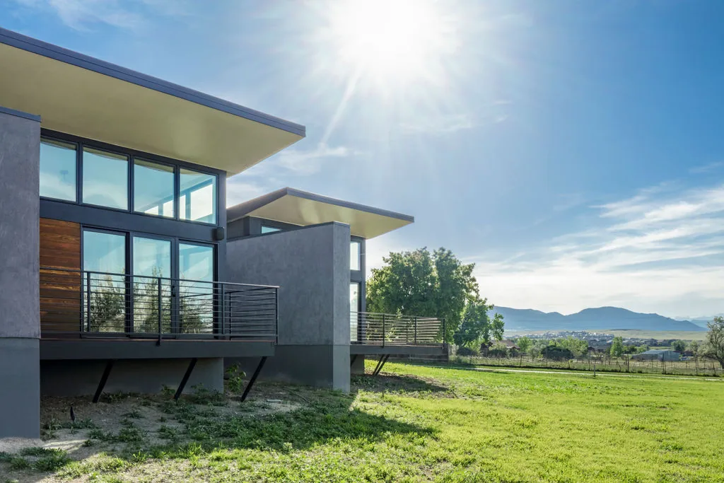 Hoff Residence features modern flat roof structures with large windows and metal balcony railings.