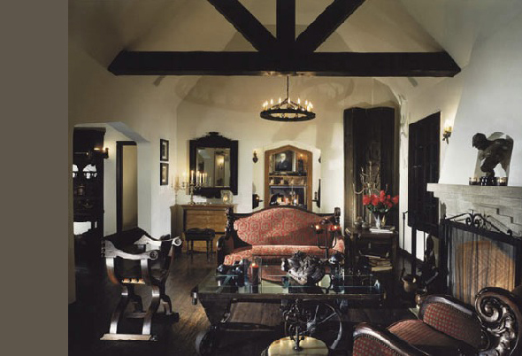 Living room features vaulted ceiling with exposed beams, antique furniture, and fireplace in Alta Vista project.