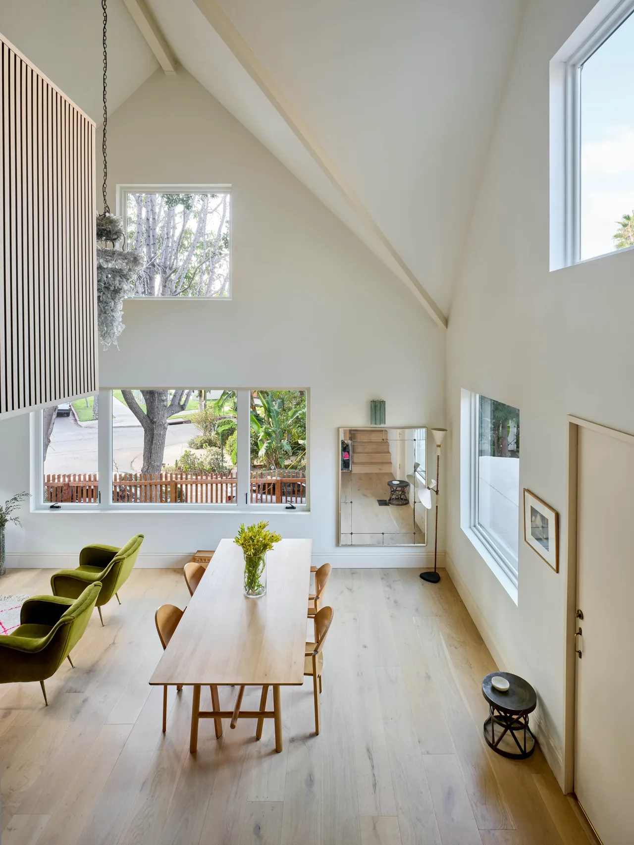 Dining space in Silver Lake Treehouse features vaulted ceilings and expansive windows for natural light.