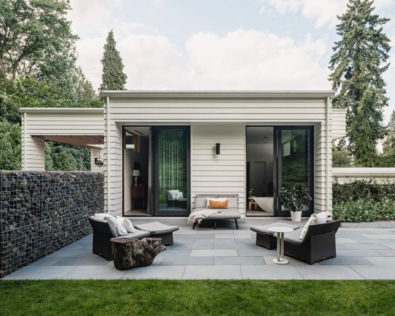 Outdoor patio area with seating and garden view at the Idea House by JHL Design in Portland.