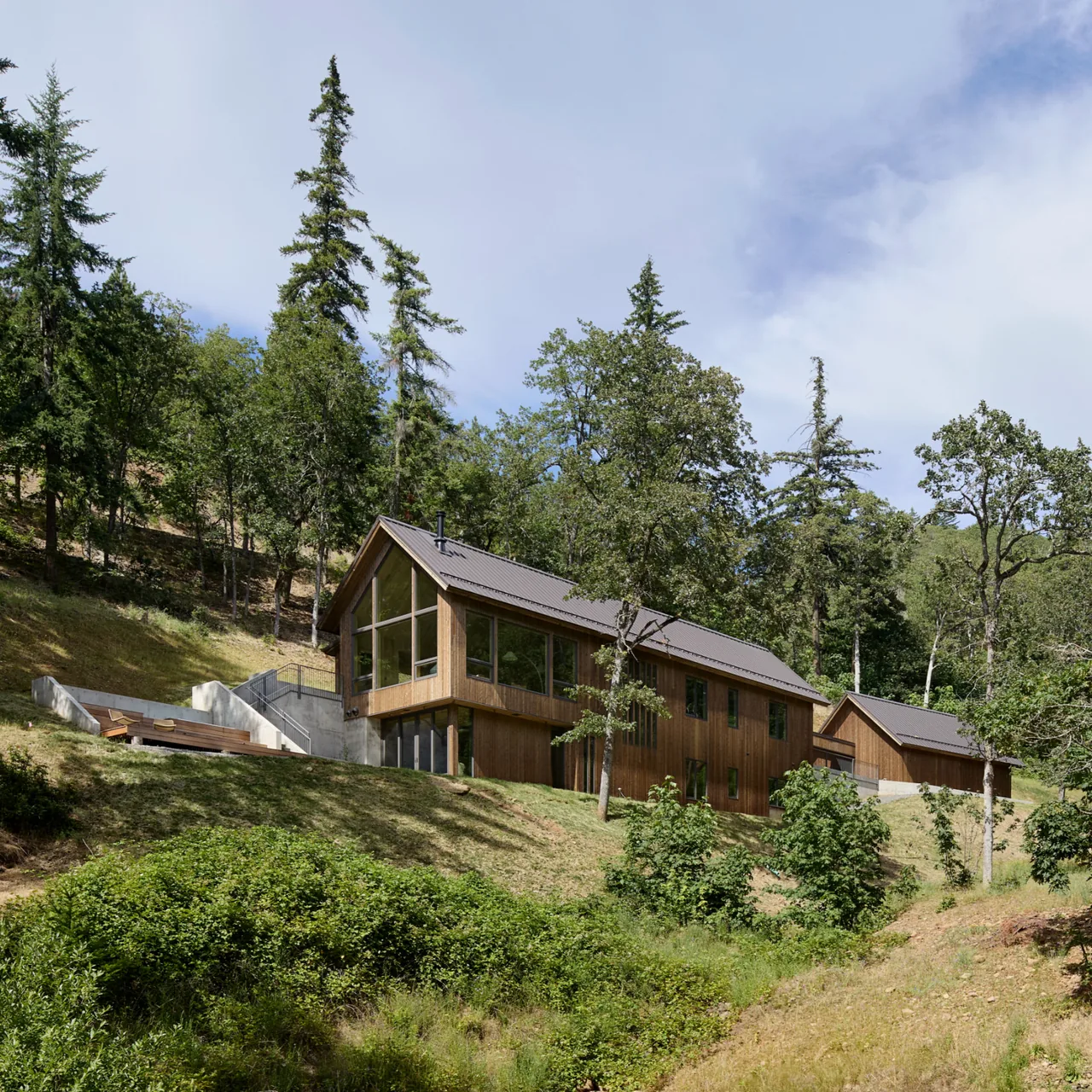 Sanford Spring features modern wood siding and a gable roof designed by JHL Design in Portland.