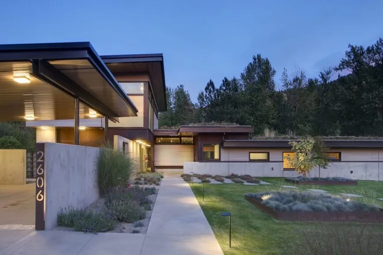 Montana Creekside Residence features flat roofs and concrete walls with wood accents, designed by Studio Zerbey.