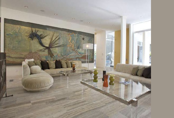 The Crescent project living room features neutral sofas, glass tables, and a large mural wall art.