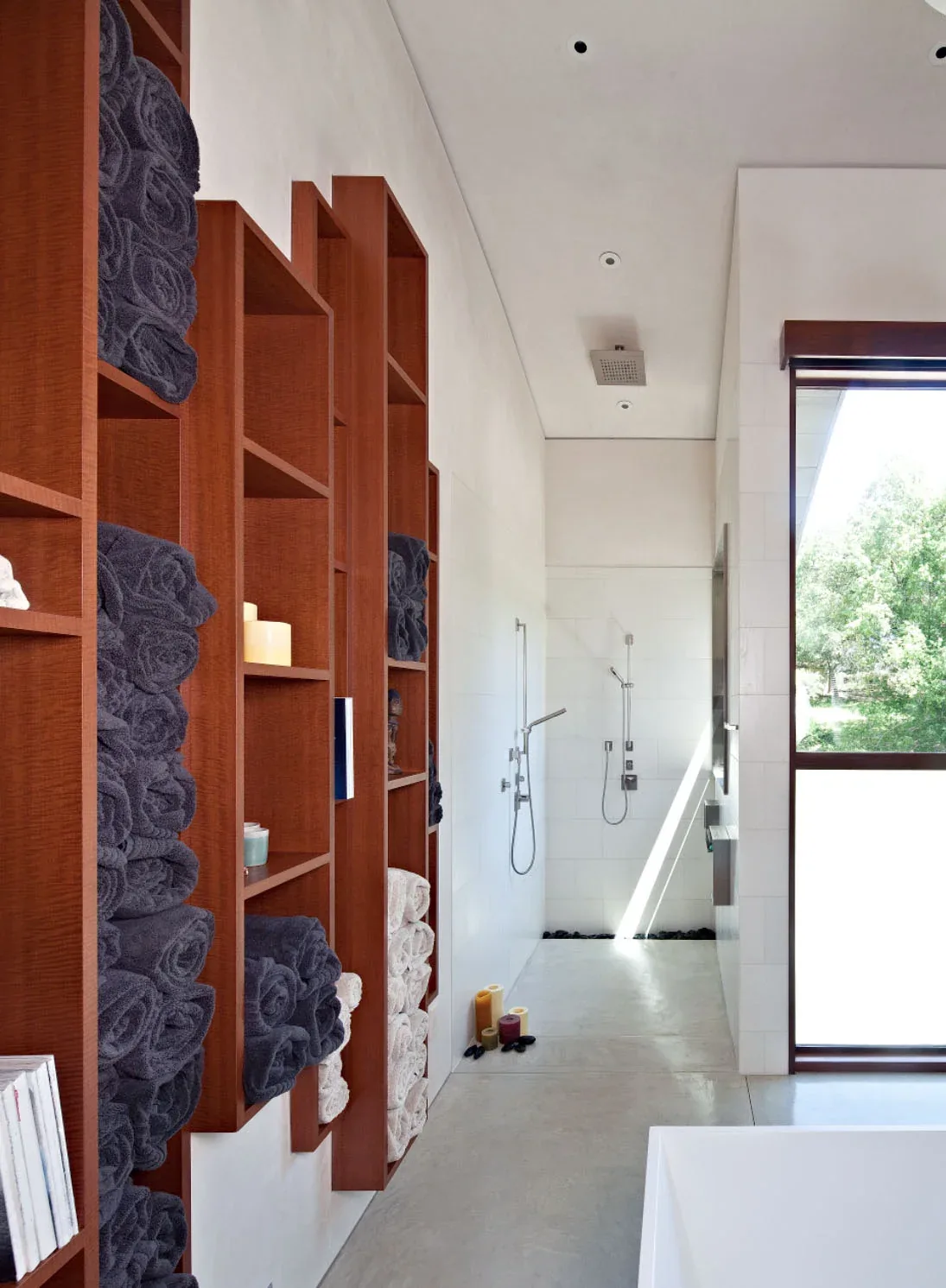 The Saratoga Creek House bathroom features wood cabinetry with open shelving and a walk-in shower with modern fixtures.