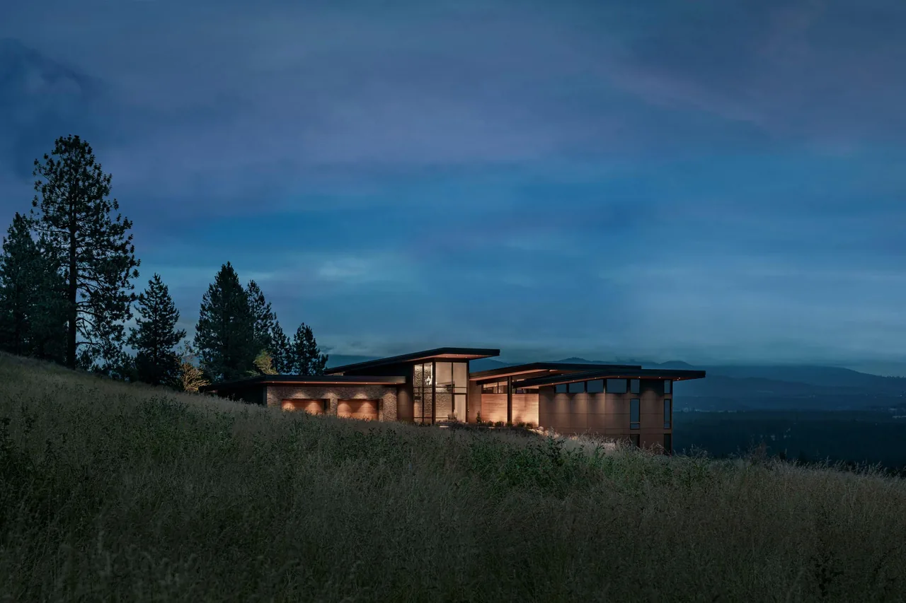 Saddle Mountain project by Uptic Studios features a modern home with illuminated windows at dusk.