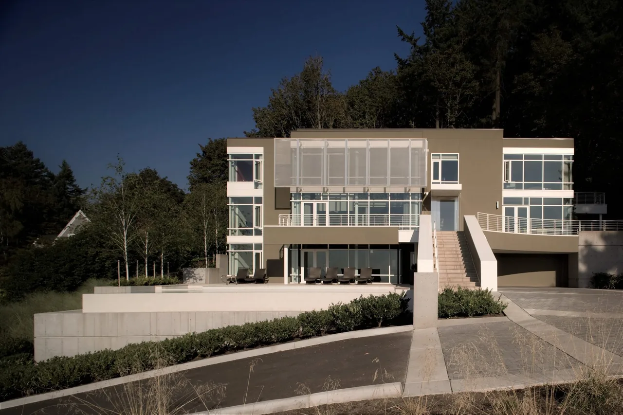 The Hewett Street Residence by TVA Architects INC. features large glazing and a concrete terrace in a modern design.