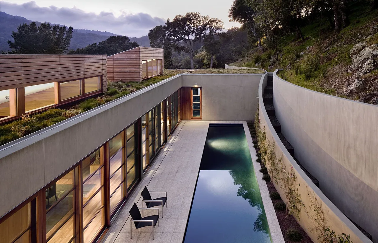 Kentfield Residence features a reflecting pool courtyard with concrete walls and a grassy roof, designed by Turnbull Griffin Haesloop in San Francisco.