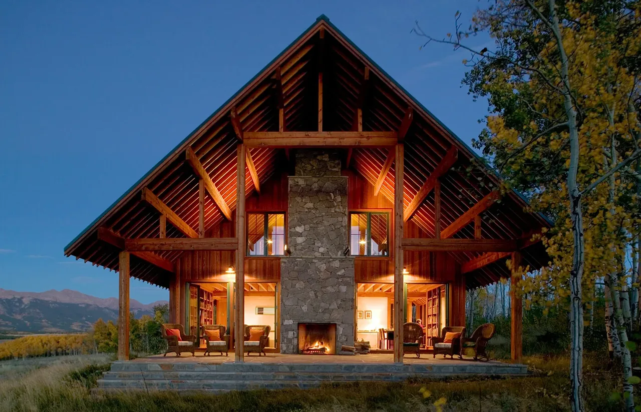 The Colorado Ranch features a prominent stone fireplace on the exterior with natural wood and exposed beams.