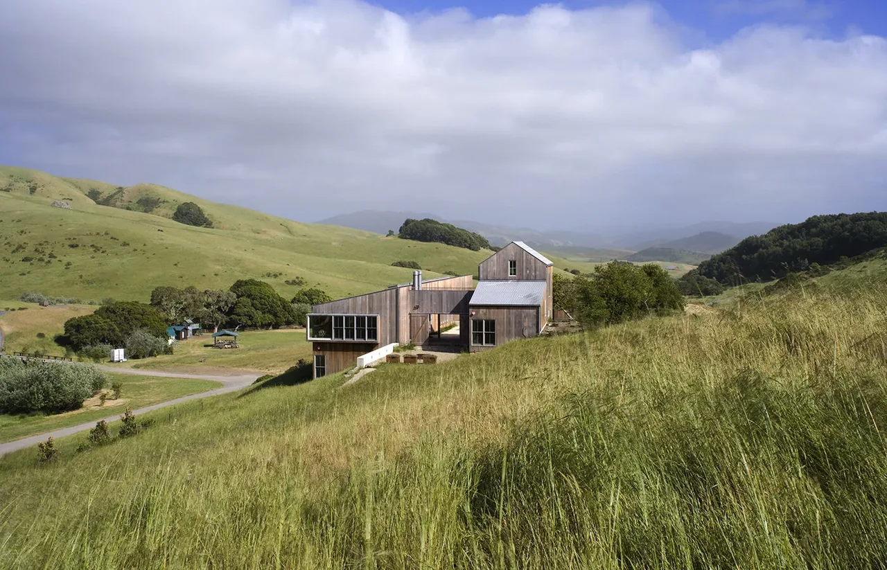 West Marin Ranch features a wood-clad exterior harmonizing with the surrounding rolling hills landscape.