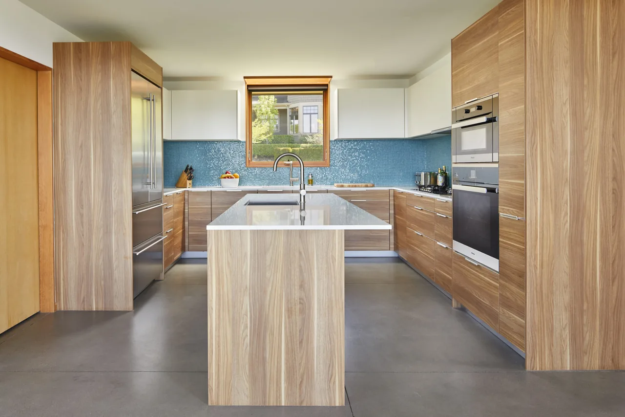 Issaquah Highlands Residence kitchen featuring wood cabinets and a central island with a modern faucet.