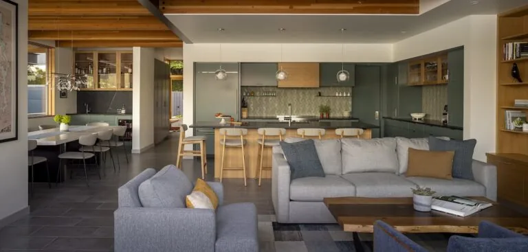 Lake Washington Residence interior showing open living space connected to kitchen with natural wood and gray tones.
