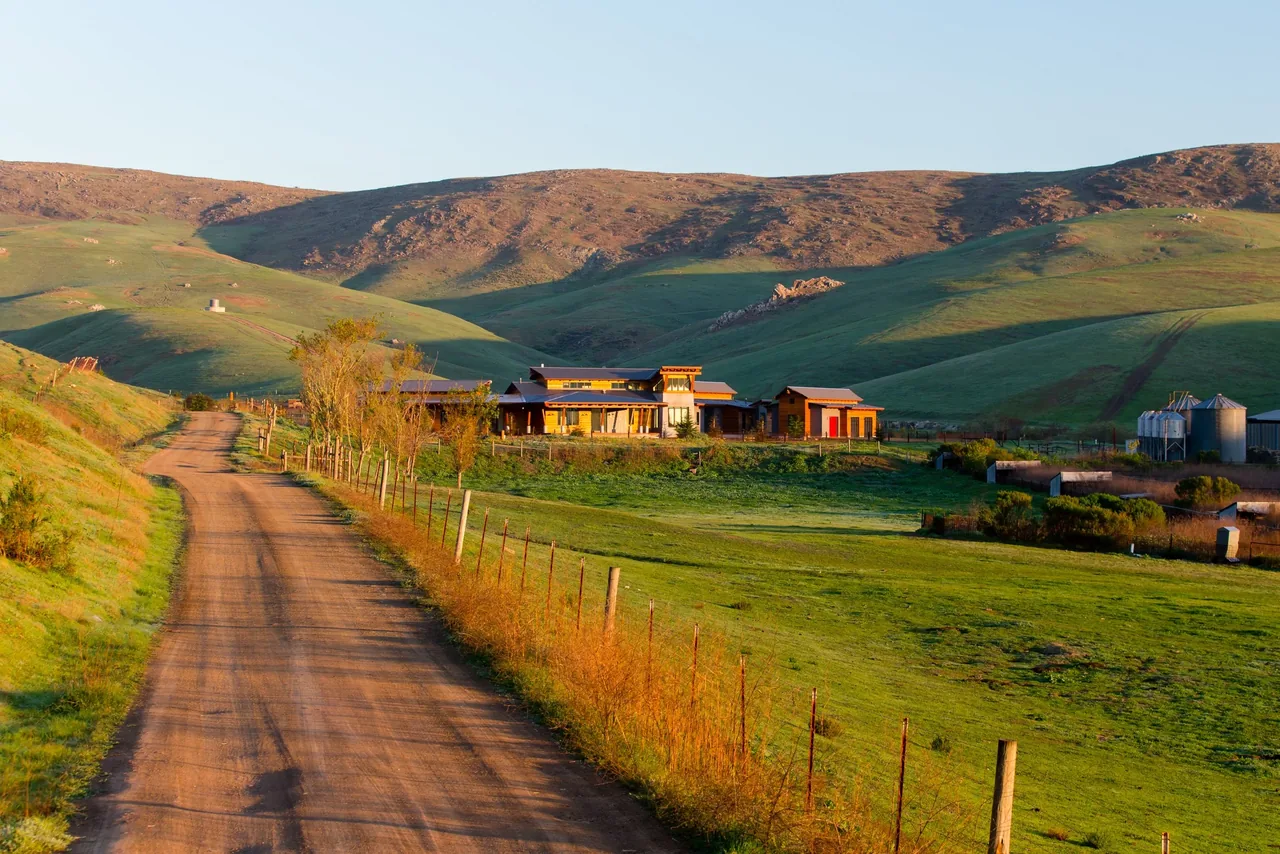 Cayucos Ranch residence by Crabtree Architecture + Design is located among open hills with a rustic setting.